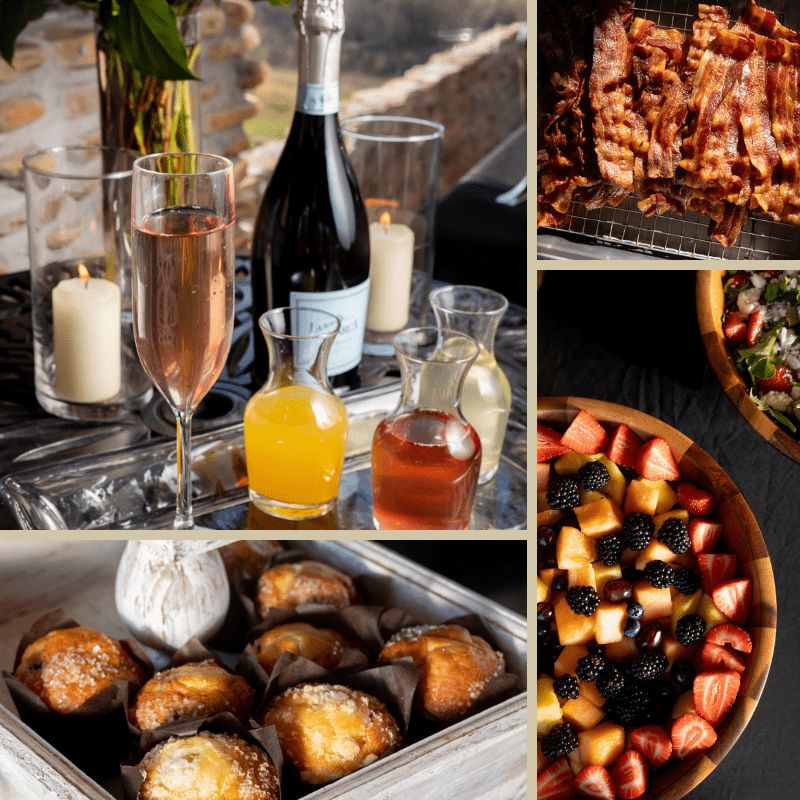 Champagne, juices, candles, bacon, pastries, and a fruit salad are arranged for a Sunday brunch at Ancient Lore Village on a dark table.